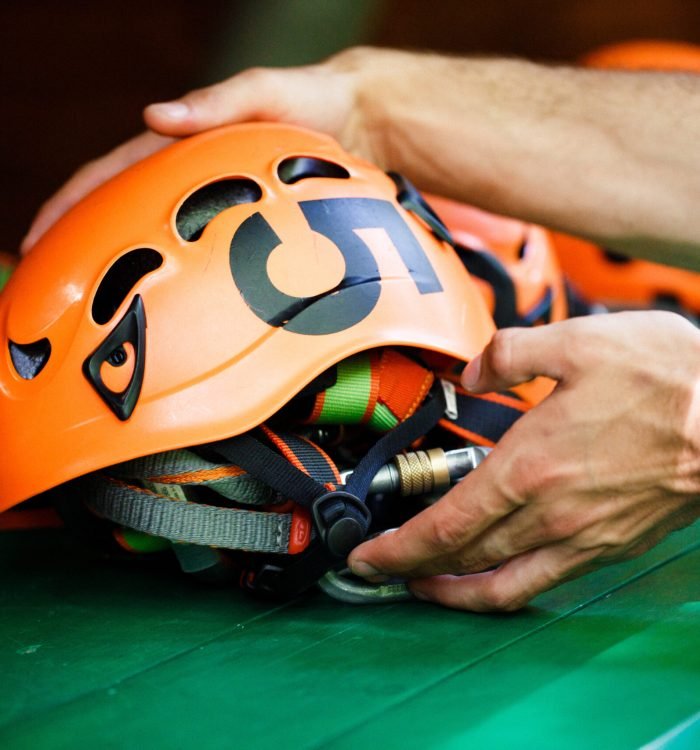 Man takes on an orange helmet with a number five